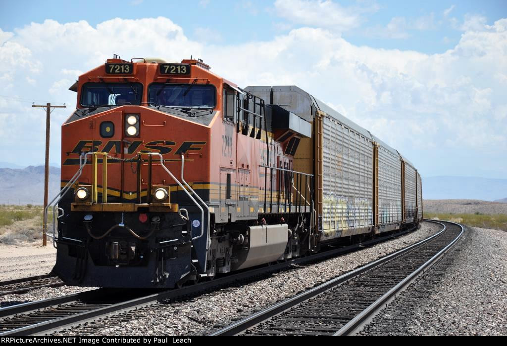 Westbound vehicle train slogs up the grade